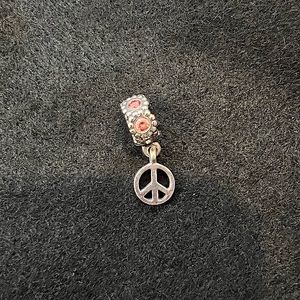PANDORA sterling silver peace charm with pink crystals